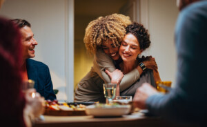 group of friends smiling at the dinner table